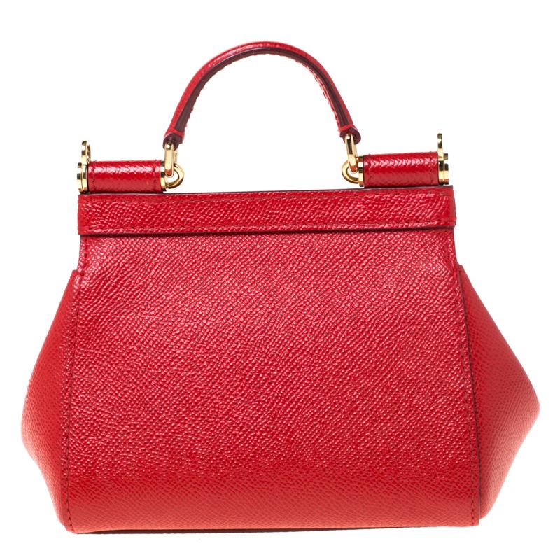 This gorgeous red Miss Sicily crossbody bag from Dolce & Gabbana is a bag coveted by women around the world. It has a well-structured design and a flap that opens to a compartment with fabric lining to fit your essentials. The bag comes with