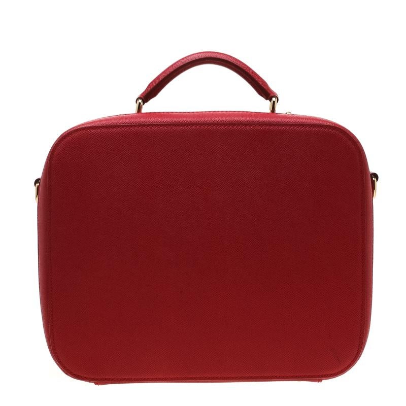 Exclusively designed from the house of Dolce and Gabbana this bag will upgrade your style quotient to another level. Flaunting a structured shape, the bag is crafted from leather in a red hue. Equipped with a shoulder strap and a top handle, the