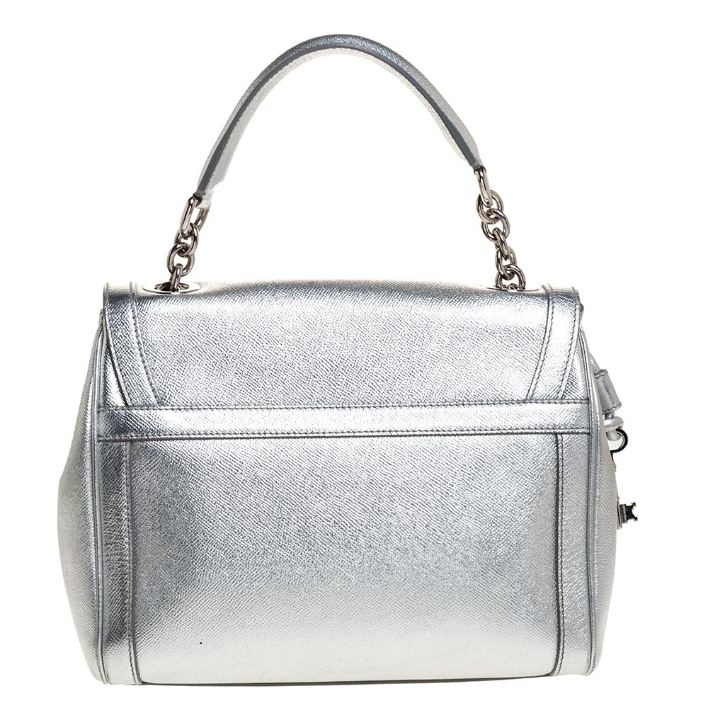 This Dolce & Gabbana handbag is a must-have for the fashion-conscious. Embrace your natural style with this alluring handbag. Crafted from leather, it has a lovely silver hue. It has a stunning silhouette and features a padlock detailing on the