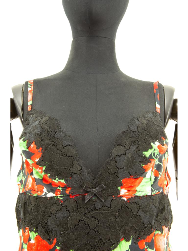 This strawberry and blossom printed silk camisole is typical of the House and its use of underwear as outerwear, based on a vintage lingerie design. The black lace and strawberry motif are also house signatures. 

Adjustable straps. Printed silk. 12