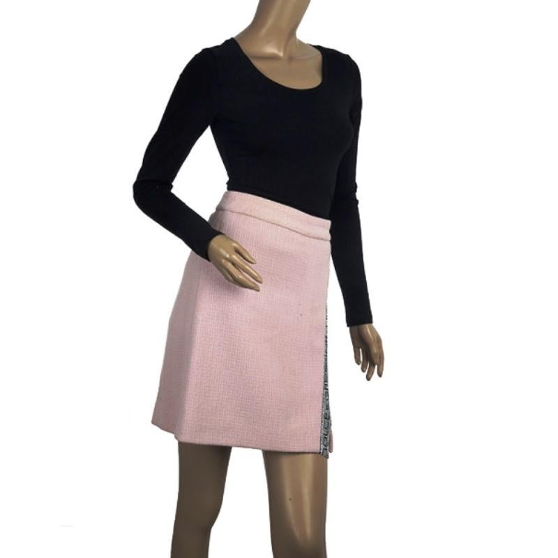 This adorable skirt by Dolce and Gabbana is made from a wool blend in a lovely pink color. It is accented with the crystallized band name at the front and is designed in a wrap effect. It is equipped with a back zipper. 

Includes: The Luxury Closet