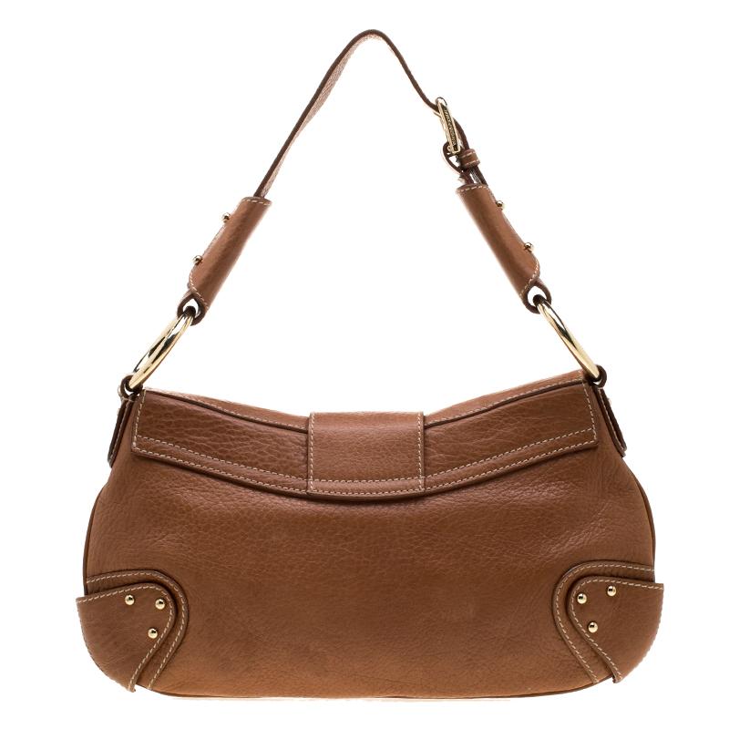 Well-made and reliable, this hobo is from Dolce and Gabbana. It has been crafted from leather and enhanced with a D-ring on the front flap. The bag is equipped with a well-sized fabric interior, a shoulder handle, and gold-tone hardware.

Includes: