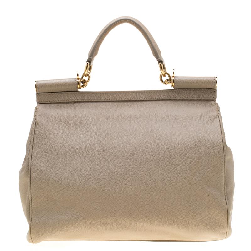 This much-coveted Miss Sicily tote from Dolce and Gabbana is the perfect everyday bag. Crafted with textured taupe leather, it comes accented with gold-tone hardware. With a structured top, it has a sturdy top handle, a flap opening with a logo