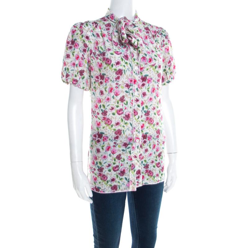 Dolce and Gabbana exhibit the finest craftsmanship in producing classic silhouettes that lends you a free-flowing look with a tasteful twist of sober and soothing white shade. Made from a fine silk blend, this blouse features a floral pattern with a