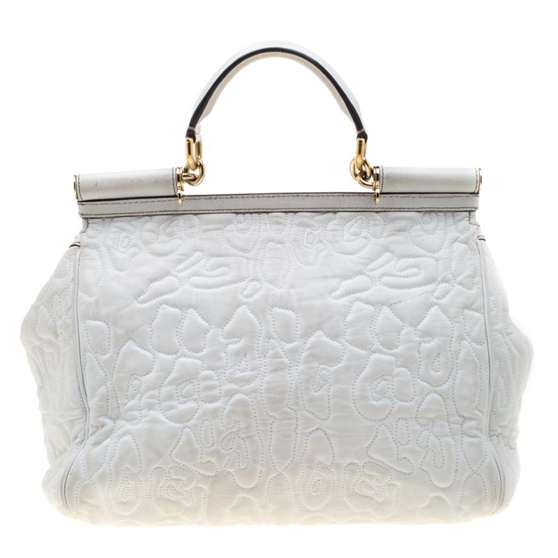 This gorgeous white Miss Sicily bag from Dolce & Gabbana is a handbag coveted by women around the world. It has a well-structured design and a flap that opens to a compartment with fabric lining and enough space to fit your essentials. The bag comes