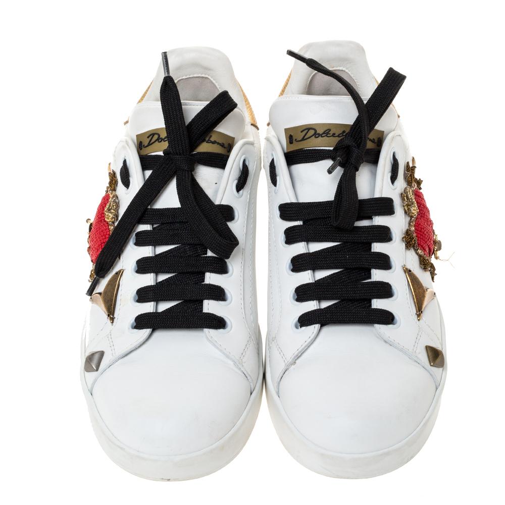 You're sure to win hearts with these sneakers from Dolce & Gabbana. Crafted from quality leather, the trendy shoes carry round toes, lace-ups, and detailing of red-hued hearts, gold-tone hardware and the brand name on the counters. They are sure to