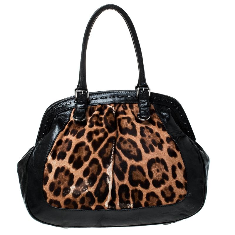 Gorgeously designed, the Miss Romantique Satchel from Dolce and Gabbana comes crafted from leopard printed calf hair and leather and features dual top handles with silver-tone buckles. It has a top closure that opens to a spacious canvas-lined