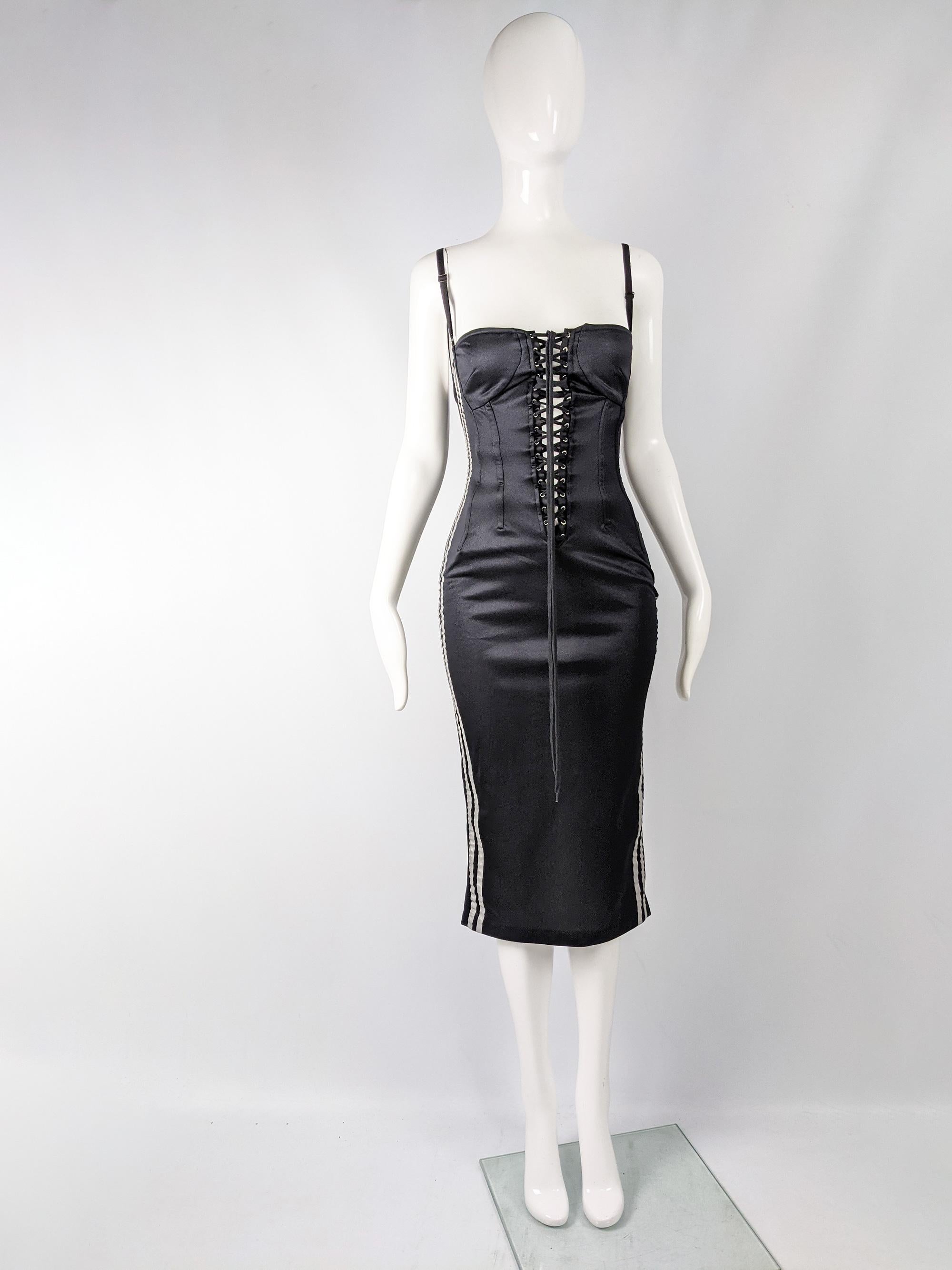 An incredible vintage Dolce & Gabbana D&G dress from the late 90s, made in Italy from a black satin. it has a boned, corset style bodice with lacing at the plunging front and back which reveals your skin underneath for a look that has loads of sex