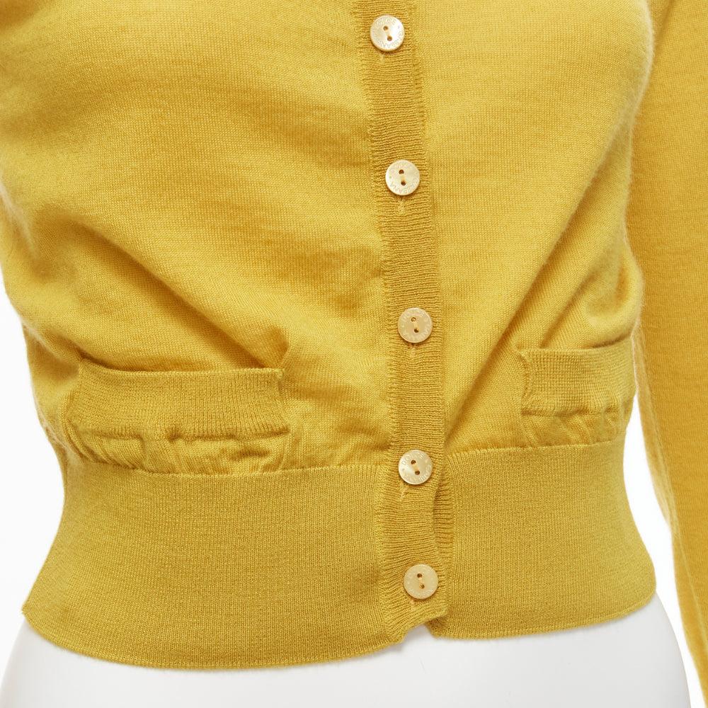 DOLCE GABBANA 100% cashmere yellow duo pocket cropped cardigan sweater IT38 XS
Reference: SNKO/A00243
Brand: Dolce Gabbana
Designer: Domenico Dolce and Stefano Gabbana
Material: Cashmere
Color: Yellow
Pattern: Solid
Closure: Button
Extra Details: