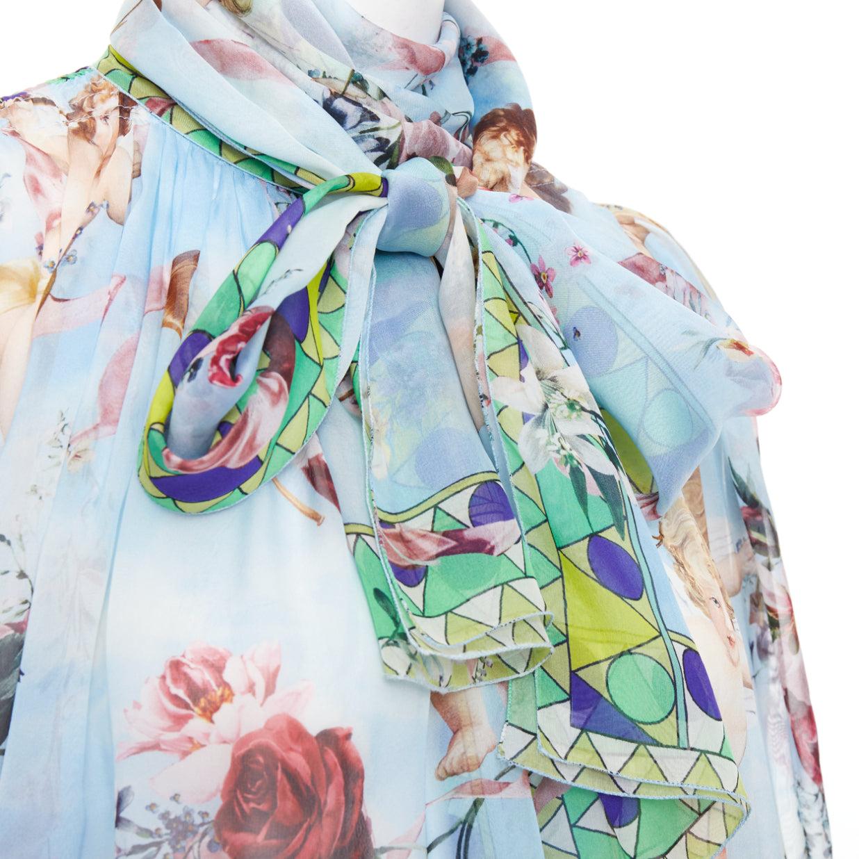 DOLCE GABBANA  100% silk blue Cherub Cupids print pussybow sheer blouse IT40 S
Reference: MECG/A00193
Brand: Dolce Gabbana
Designer: Domenico Dolce and Stefano Gabbana
Material: Silk
Color: Blue, Multicolour
Pattern: Photographic Print
Closure: Self