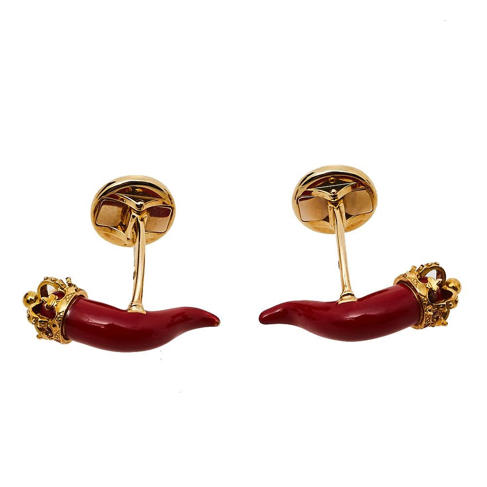 Even a small pair of statement accessories can make a big style impression, as shown by these Dolce & Gabbana Good Luck cufflinks. The 18K yellow gold design has a horn-shaped motif, covered in red enamel and detailed with a little crown. The