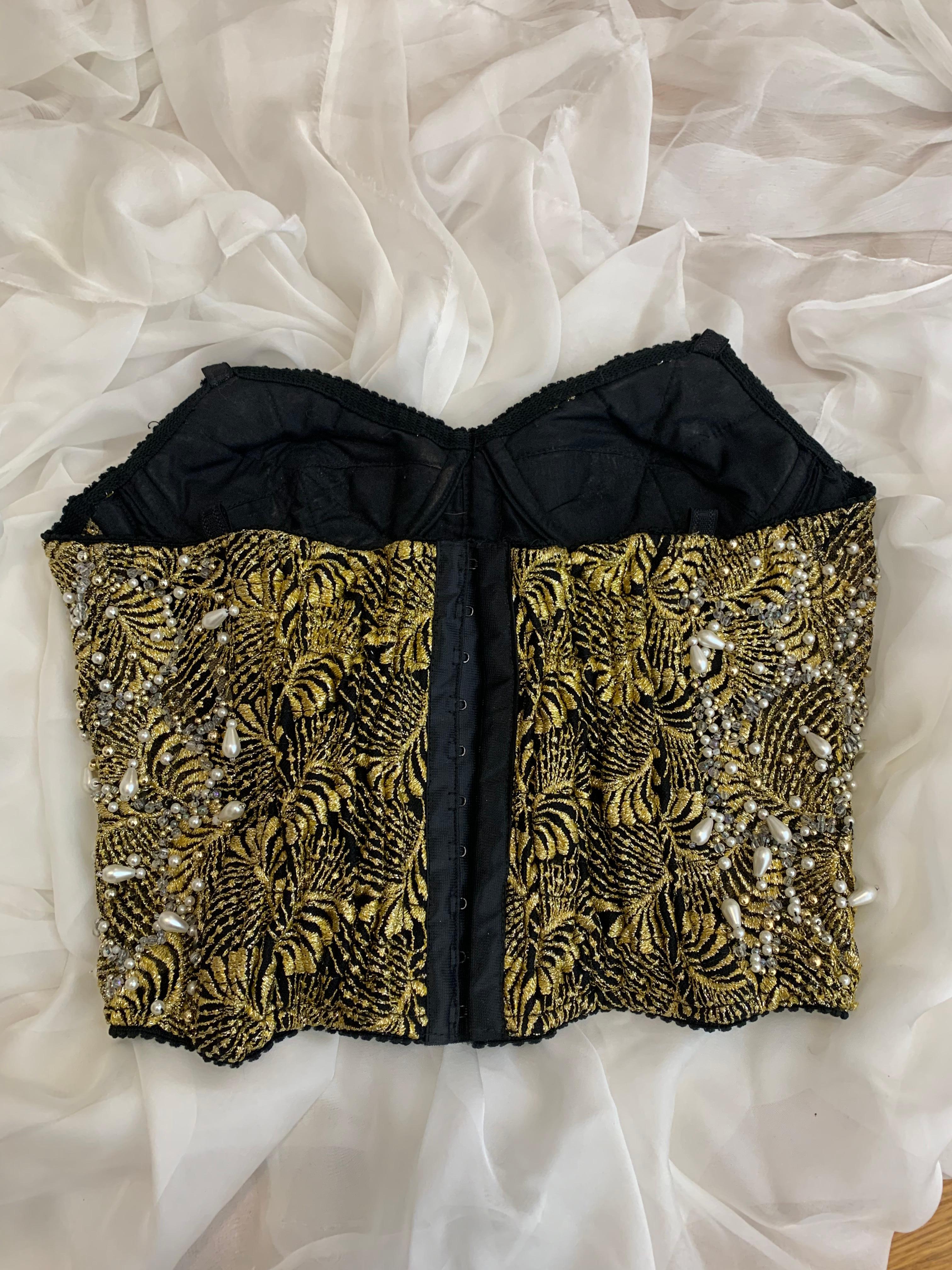 Super Rare Dolce Gabbana 1990’s beaded pearls gold and black corset top 

Good vintage condition with normal wear. No straps. There are hoops for straps so you can put any straps you want 

There is no size label. Fits like S and best for A-B cup.