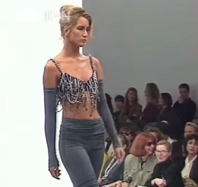 Dolce & Gabbana 1991 S/S. This was an iconic early inspirational collection for the designing duo.    The bralettes, corsets and short bolero mix-and-match separates adorned the runway with masses of heavy chains.  The result had a sexy feminism
