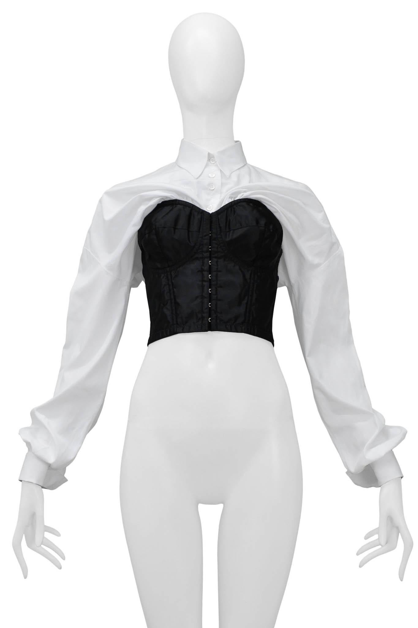Resurrection Vintage is excited to offer a vintage Dolce & Gabbana black satin bustier top featuring hook and eye center front closure, attached white cotton button-down shirt with long sleeves, and folding collar.  

Dolce & Gabbana
Size 42
Satin