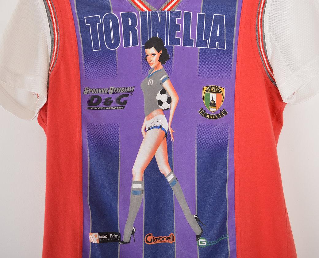 Fun 2000's Dolce & Gabbana nylon football style T-shirt with Pin up design on the front,  moc advertising logo details and D&G printed logo to the reverse. 
 
Features;
V-Neck
Short sleeves
Made in Italy
100% Nylon with 100% Cotton piping panels.
