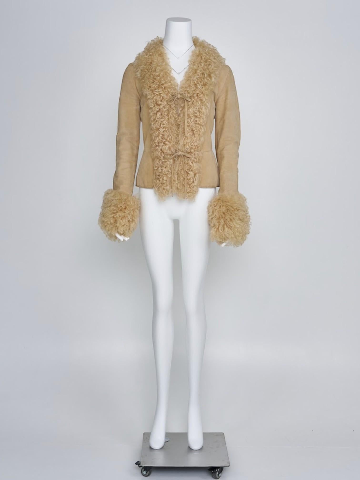 

Piece Description: A luxurious shearling coat from Dolce & Gabbana’s Fall 2001 collection, featuring soft, insulating shearling fabric with elegant tie closures. The coat’s timeless design offers both warmth and a sleek silhouette, making it a
