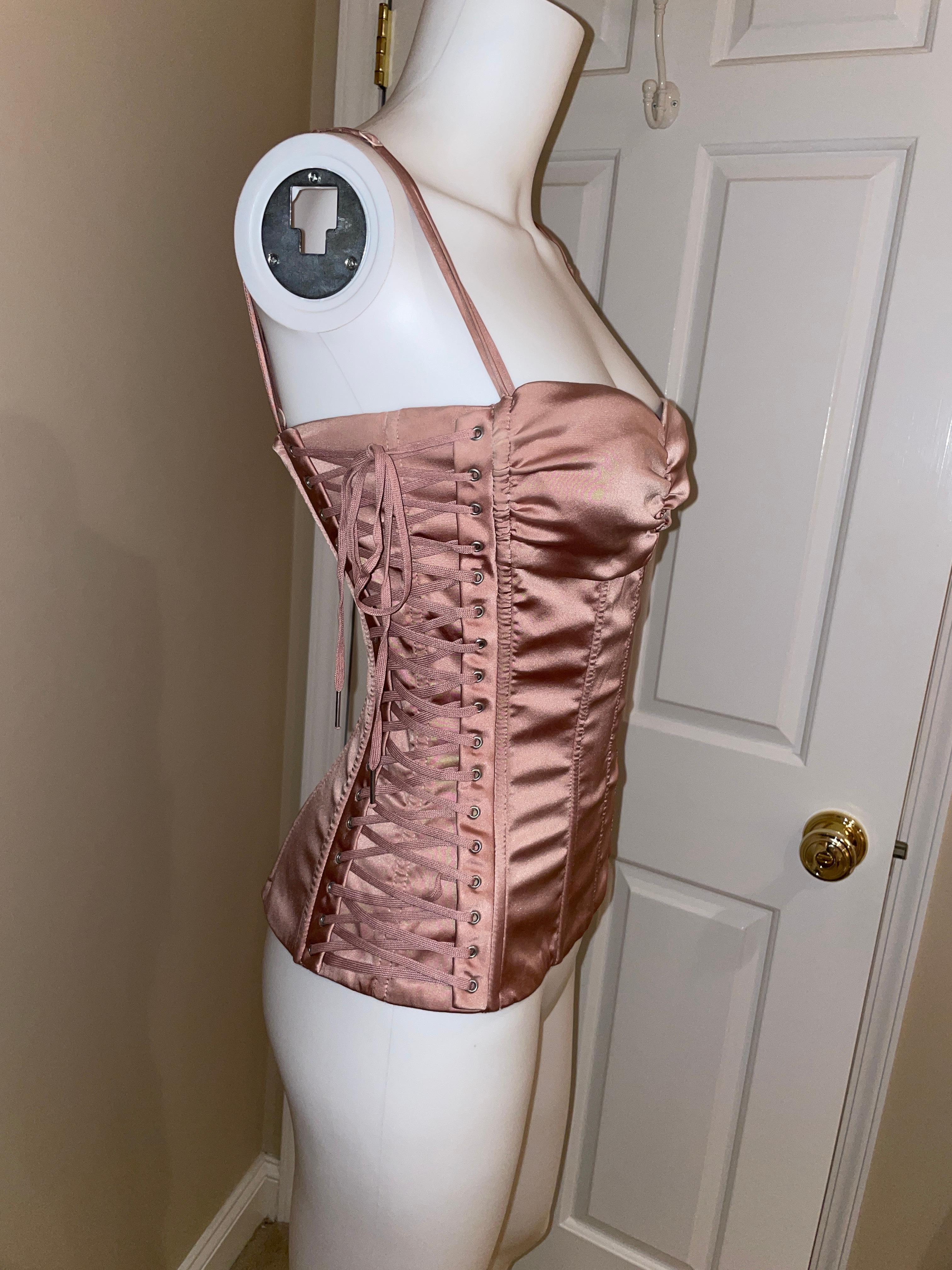 DOLCE & GABBANA 2003 sex collection boned lace up pink corset top vintage. 
Vintage Dolce and Gabbana pink silk lace up bustier top from the iconic 2003 runway sex collection. Excellent condition, no flaws noted. Harding boning to suck you in and
