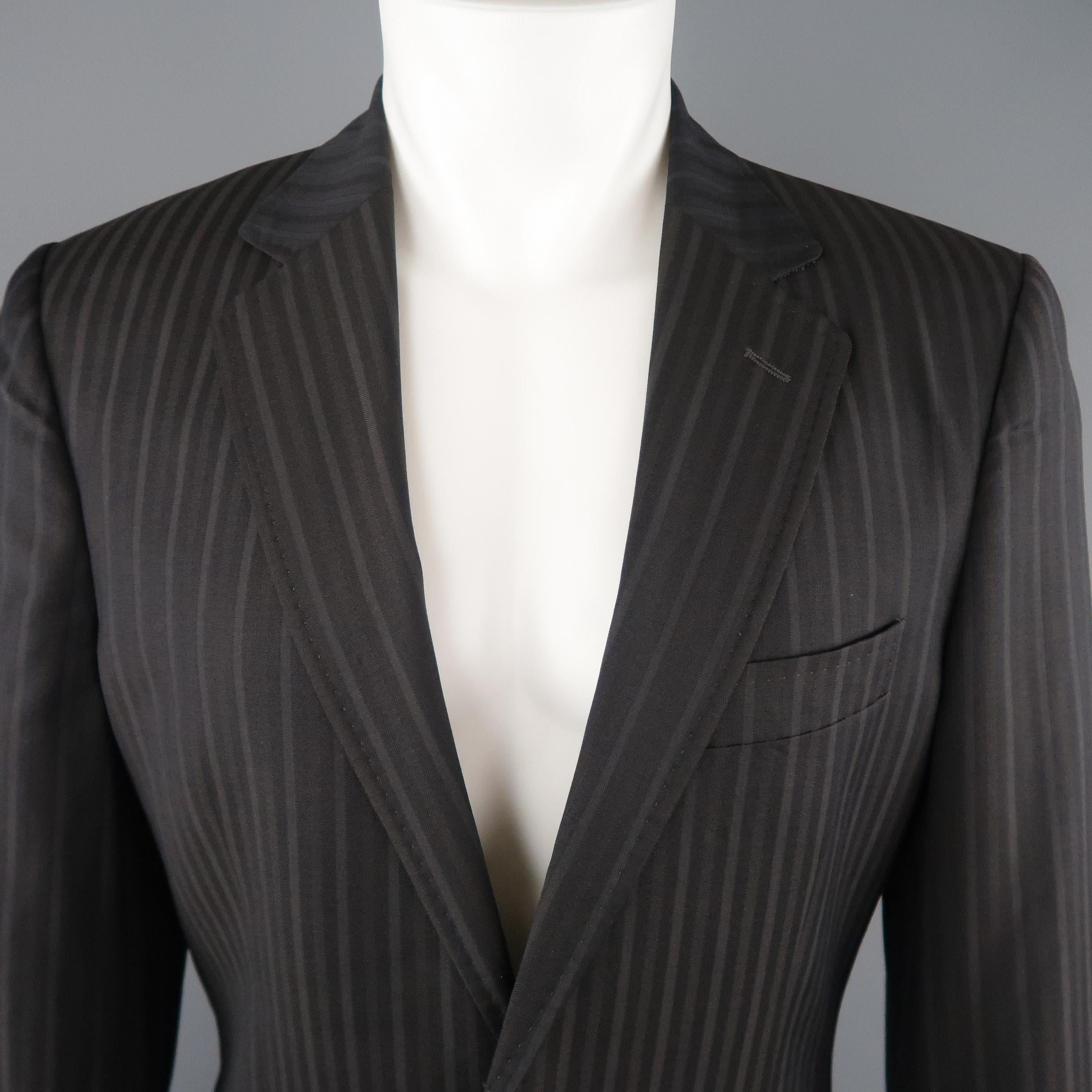 DOLCE & GABBANA sport coat comes in navy wool with brown and taupe stripe pattern, notch lapel with top stitching, single breasted two button closure, and single vented back. Made in Italy.
 
Excellent Pre-Owned Condition.
Marked: IT 48
