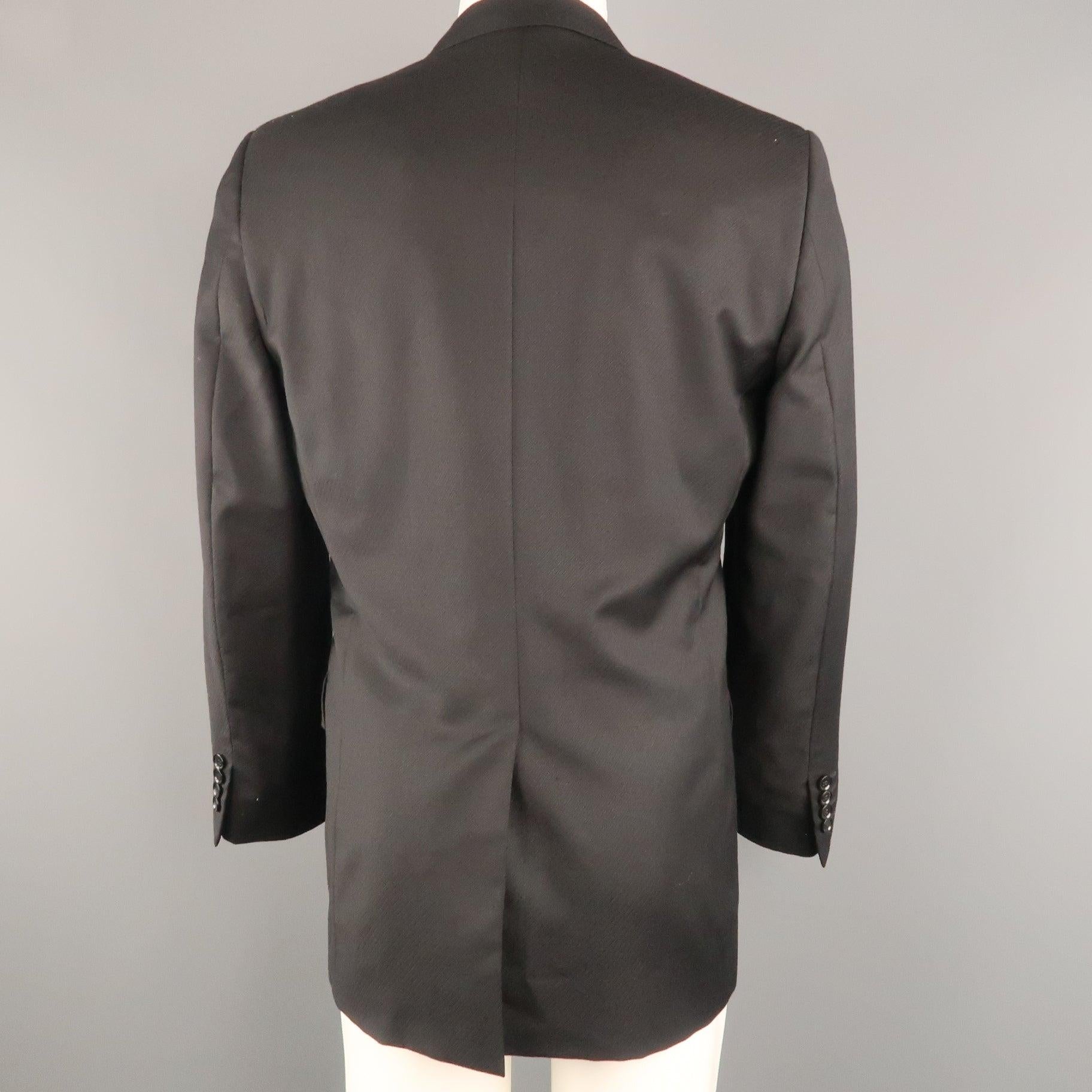 DOLCE & GABBANA sport coat comes in diagonal stripe textured wool with a top stitch notch lapel, single breasted, 
three button front, and flap pockets. Made in Italy. Excellent Pre-Owned Condition.  

Marked:   IT 48 

Measurements: 
 
Shoulder: 17