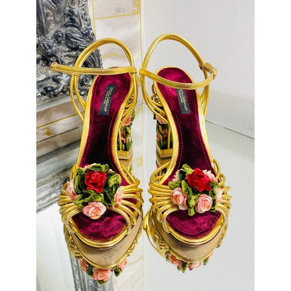Dolce & Gabbana 3D Rose Cage Sandals

Collectors Item - Strappy rose gold calfskin leather sandals with caged heels. A velvet 3D rose bouquets to the front of each and leaves winding through the caged heel also with pink roses. Buckle
