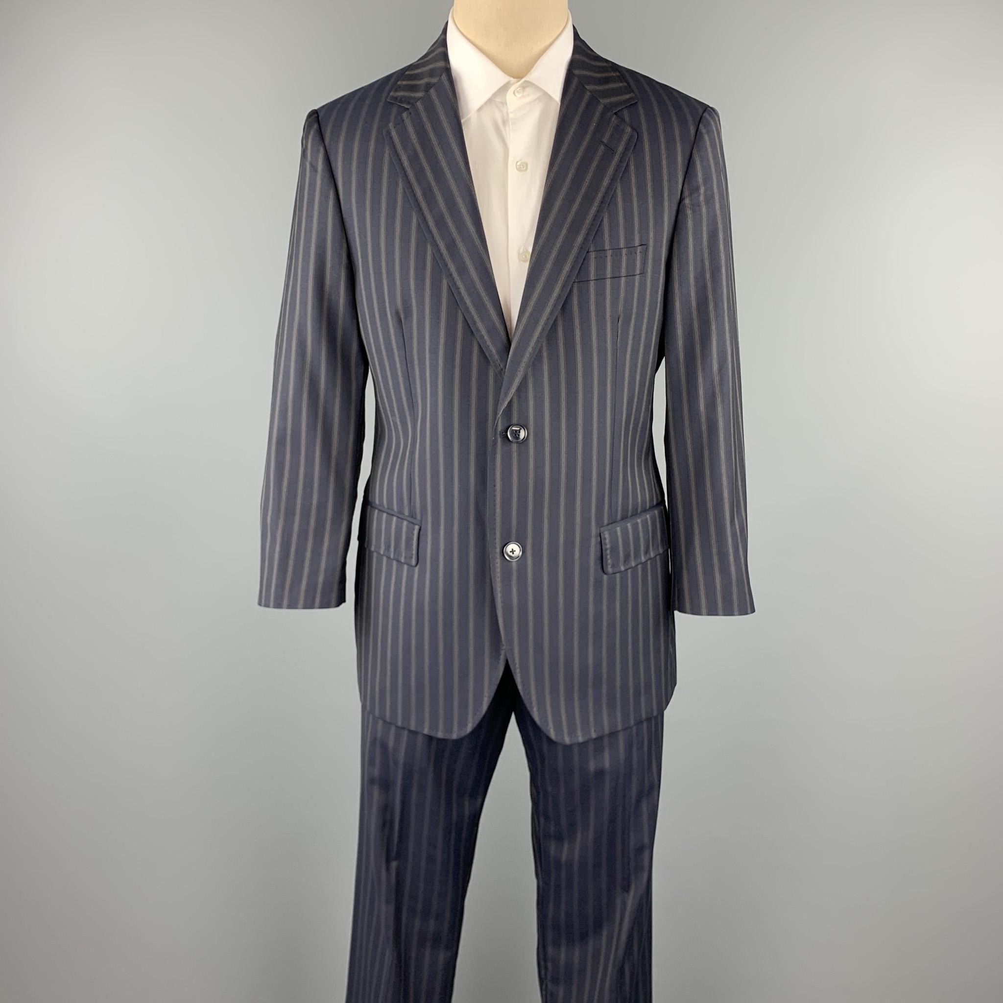 DOLCE & GABBANA suit comes in a navy stripe wool with a monogram liner and includes a single breasted, two button sport coat with a notch lapel and matching  pleated cuff front trousers.  Made in Italy.

Excellent Pre-Owned Condition.
Marked: IT