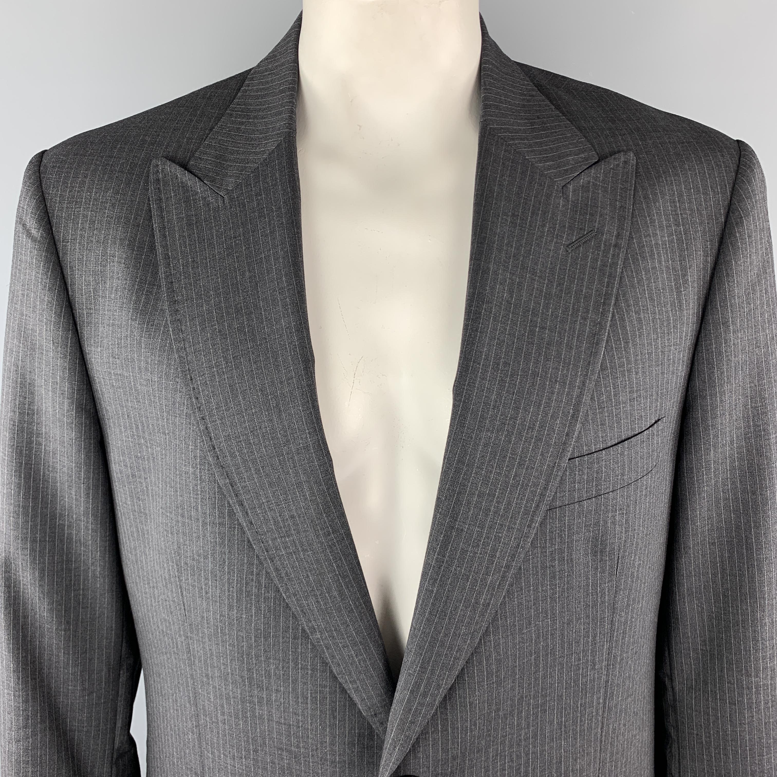 DOLCE & GABBANA Sport Coat comes in a charcoal tone in a striped wool material, with a peak lapel, slit and flap pockets, two buttons at closure, single breasted, buttoned cuffs, and a single vent at back. Made in Italy. 

Excellent Pre-Owned