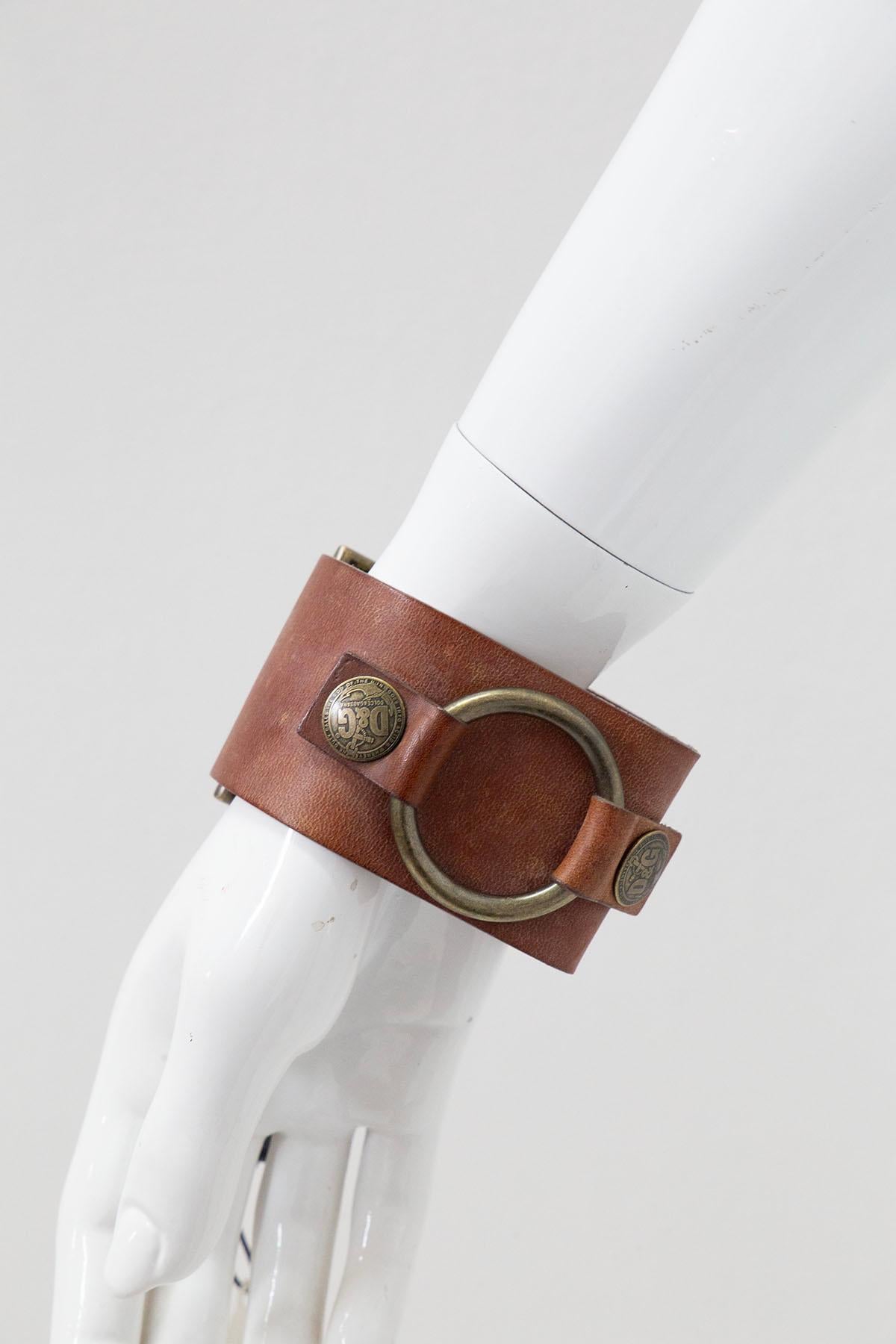 Magnifique bracelet réglable en cuir conçu par Dolce&Gabbana dans les années 1990, avec le nom de la marque en relief.
Le bracelet a une structure assez épaisse, impossible à manquer. Il est entièrement réalisé en beau cuir, dans sa couleur