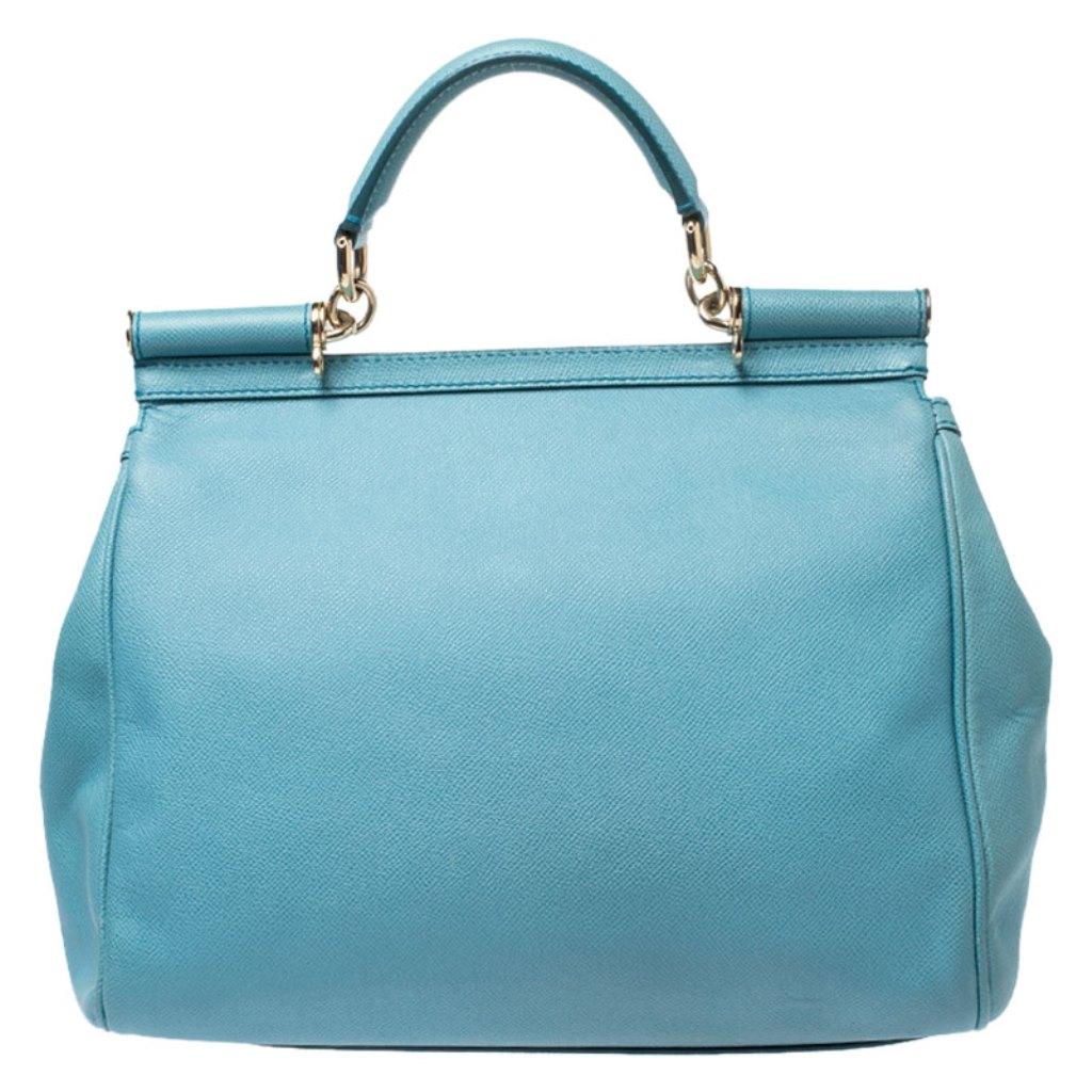 This gorgeous aqua blue Miss Sicily bag from Dolce & Gabbana is a handbag coveted by women around the world. It has a well-structured design and a flap that opens to a compartment with fabric lining and enough space to fit your essentials. The bag