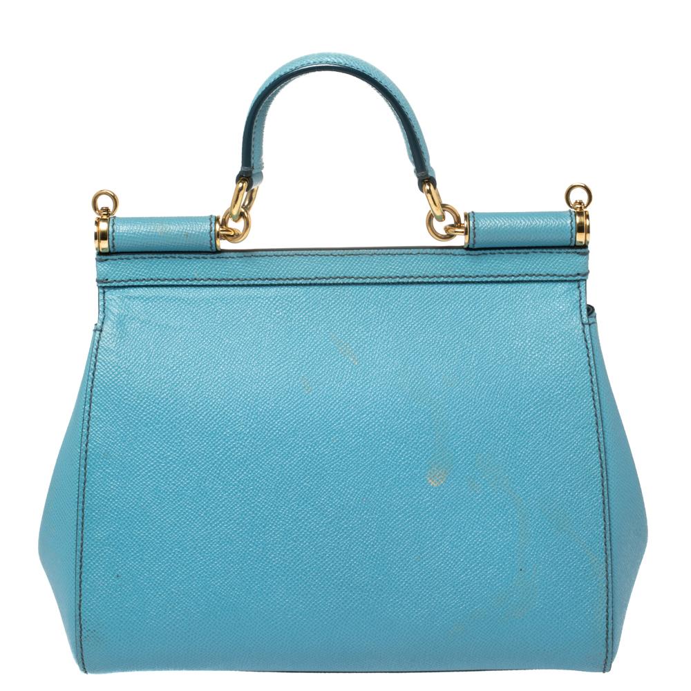 The iconic Miss Sicily bag by Dolce & Gabbana is named after Domenico Dolce's native land and exhibits the aesthetic of Italian glamour. The neat silhouette is made from leather in a baby blue shade and features a front flap accented with the