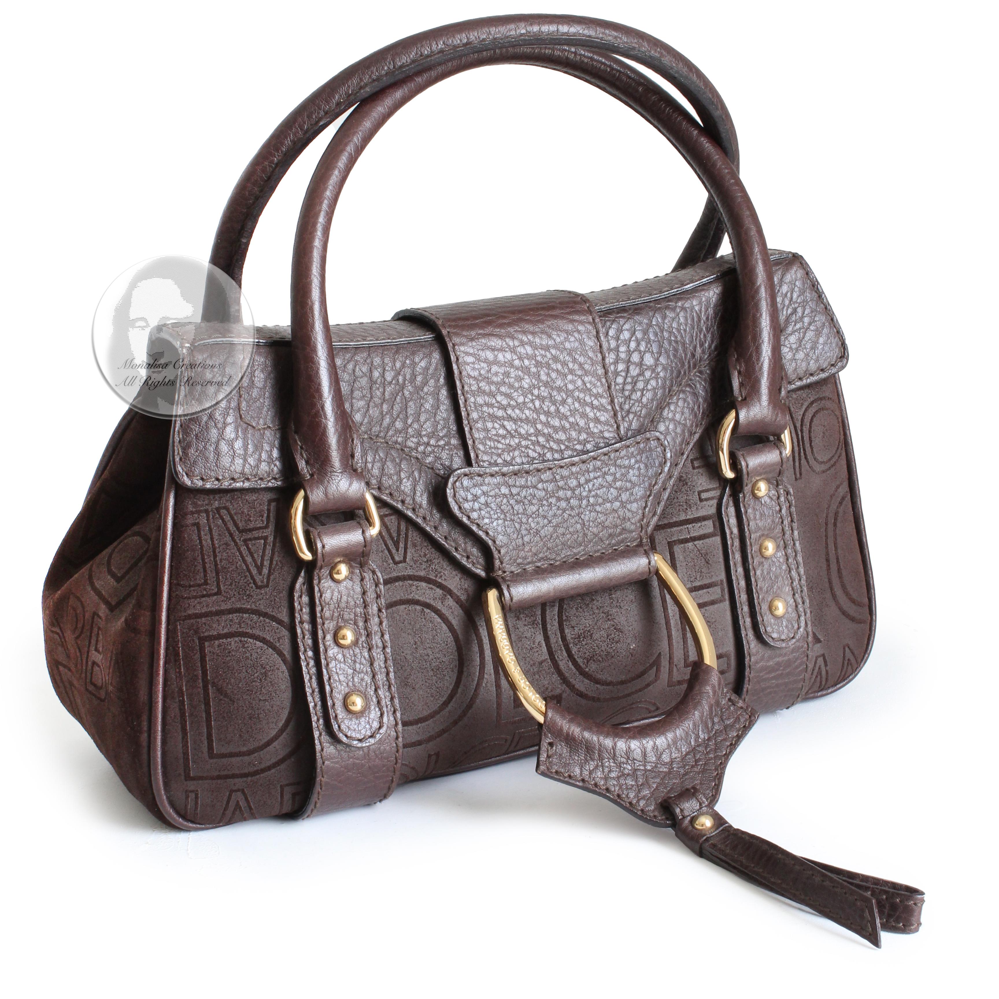 Authentic, preowned Dolce & Gabbana brown D-ring flap bag, likely from the 2000s. 

Made from sueded leather with pebbled leather trim, it features abstract Dolce & Gabbana logos throughout. Fastens with hidden magnet under flap and lined in logo