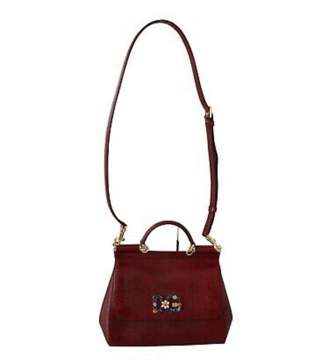 DOLCE & GABBANA
Absolutely stunning, 100% Authentic, brand new with tags Dolce & Gabbana bag purse. 
Model: Sicily Bag
Color: Red bordeaux
Material: 100% Leather
Multicolor crystal DG
Magnetic closure
Leopard print inner lining
Inside pocket with