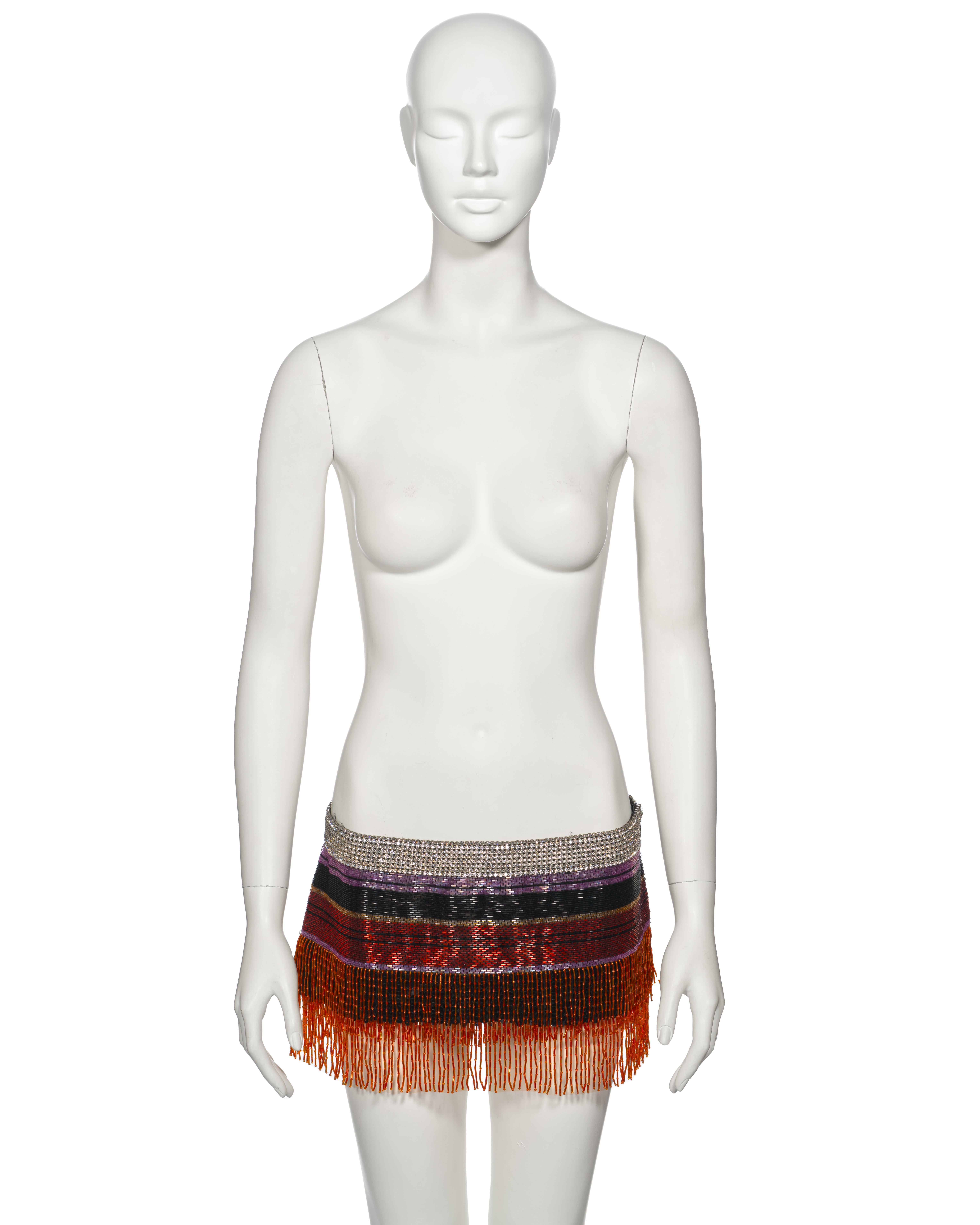 ▪ Archival Dolce & Gabbana Micro Mini Skirt 
▪ Spring-Summer 2000 
▪ Sold by One of a Kind Archive
▪ Multicoloured striped bugle bead design 
▪ Swarovski crystal mesh waistband 
▪ Tired beaded fringe trim 
▪ Sequin underlay
▪ Silk Lining  
▪ Length: