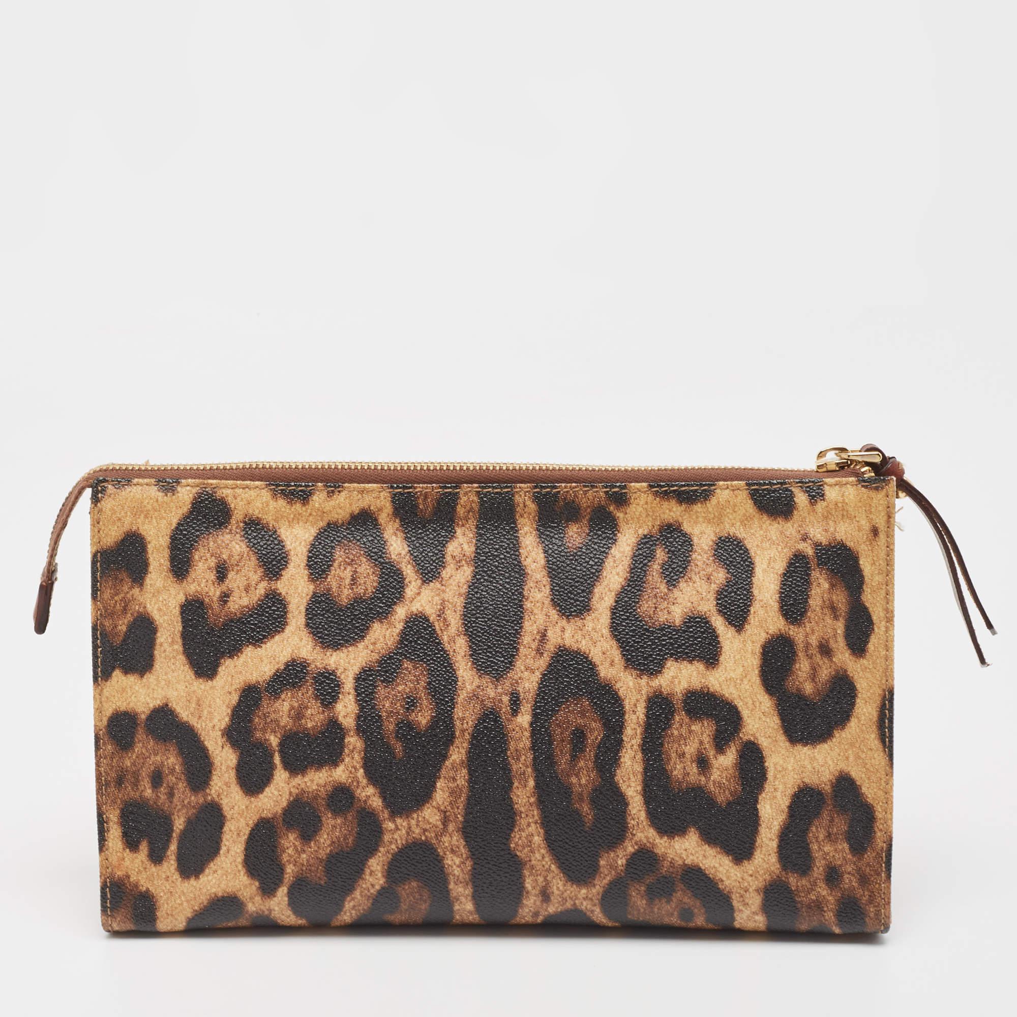 The Dolce & Gabbana case is a luxurious and stylish accessory. It features a beige and black leopard print pattern on coated canvas, with a zip closure, and a spacious interior for storing cosmetics or essentials. It exudes a bold and sophisticated