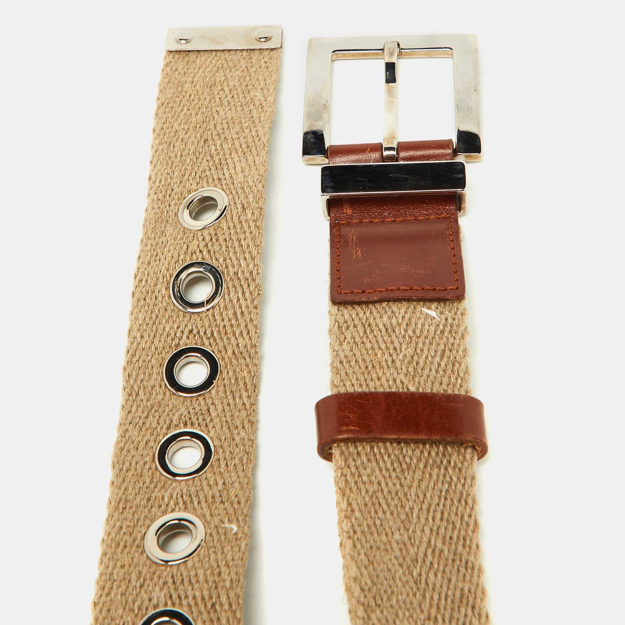 How cool is this belt from the House of Dolce and Gabbana This belt is made from beige canvas and leather. It is enhanced with a silver toned logo plaque that has the brands signature.