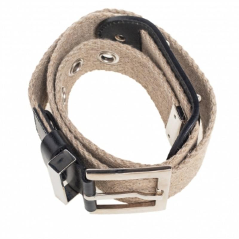 Dolce & Gabbana's beige belt is enhanced with a metal logo plaque that depicts the brand's signature, reflecting the house’s play on branding. It’s expertly crafted in canvas with a silver-tone pin buckle at the center.