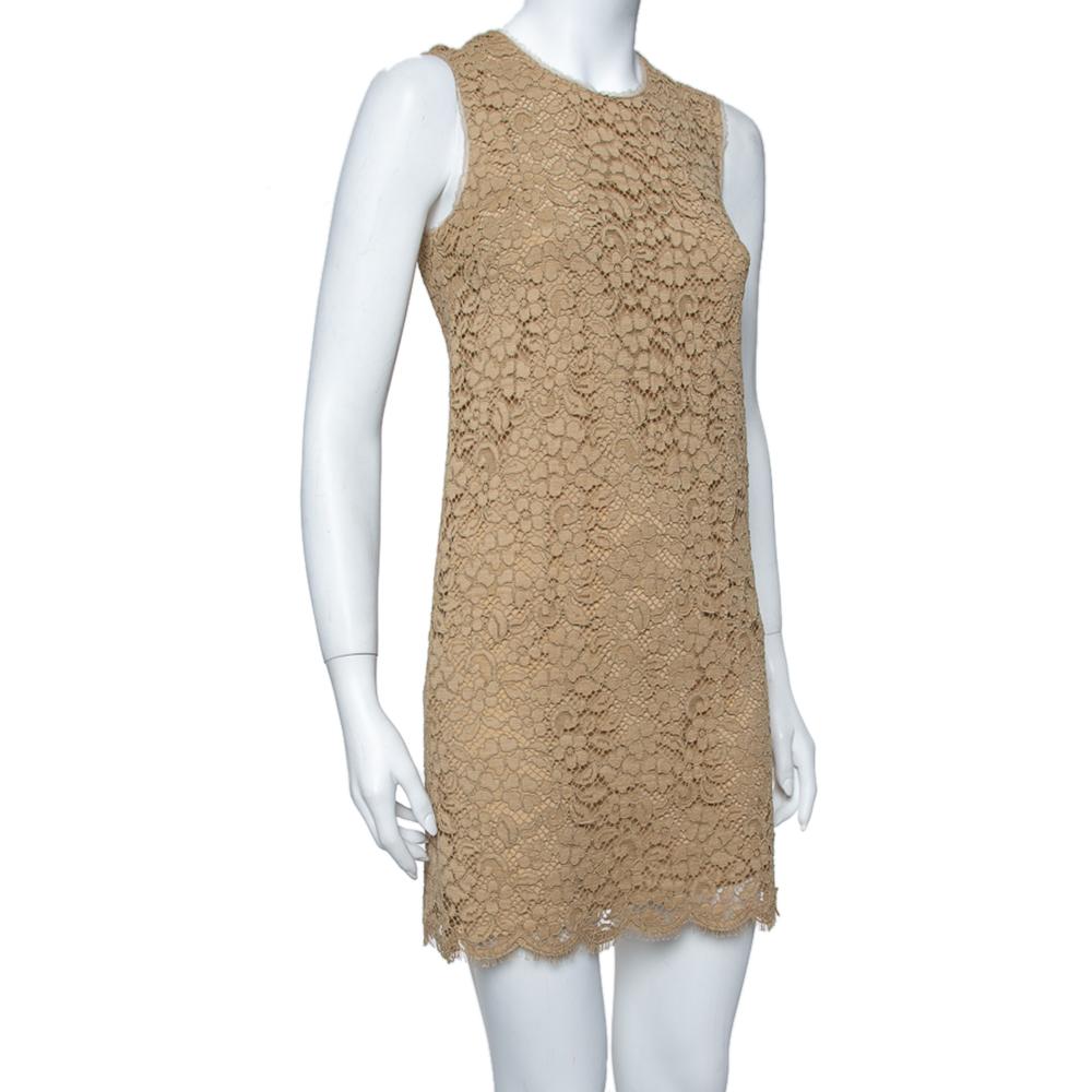 Elegant and classy, this is one dress that every woman dreams of having. This Dolce & Gabbana sleeveless dress has a floral lace overlay, a round neckline, and a back zipper. It also has a beige hue, which will make the dress look fabulous when