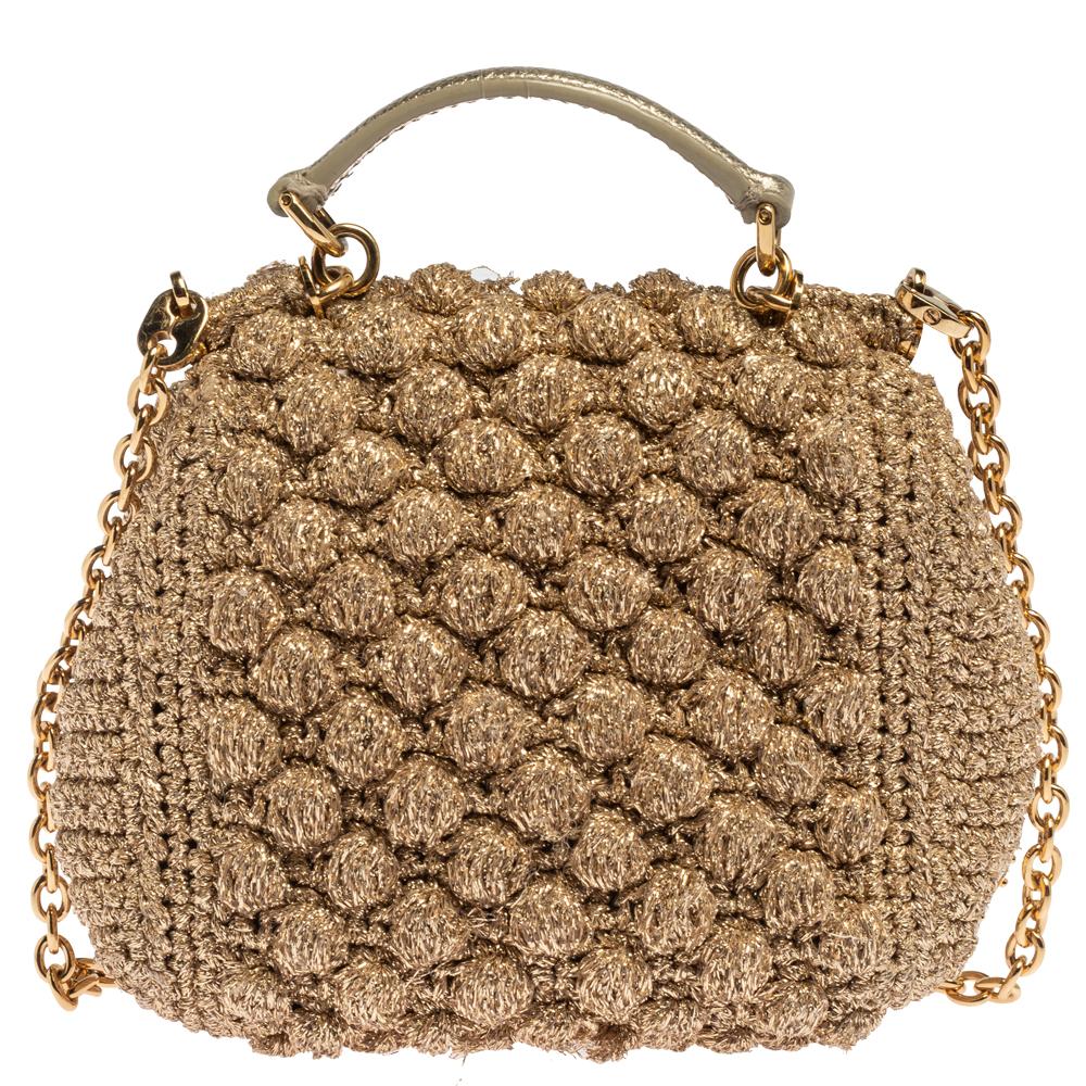 A beautiful bag from Dolce & Gabbana to light your style. It is a definite must-have. This bag comes made from lurex fabric in a soft beige and designed with a top handle, a shoulder chain, and a well-sized interior secured by a flap. You'll love