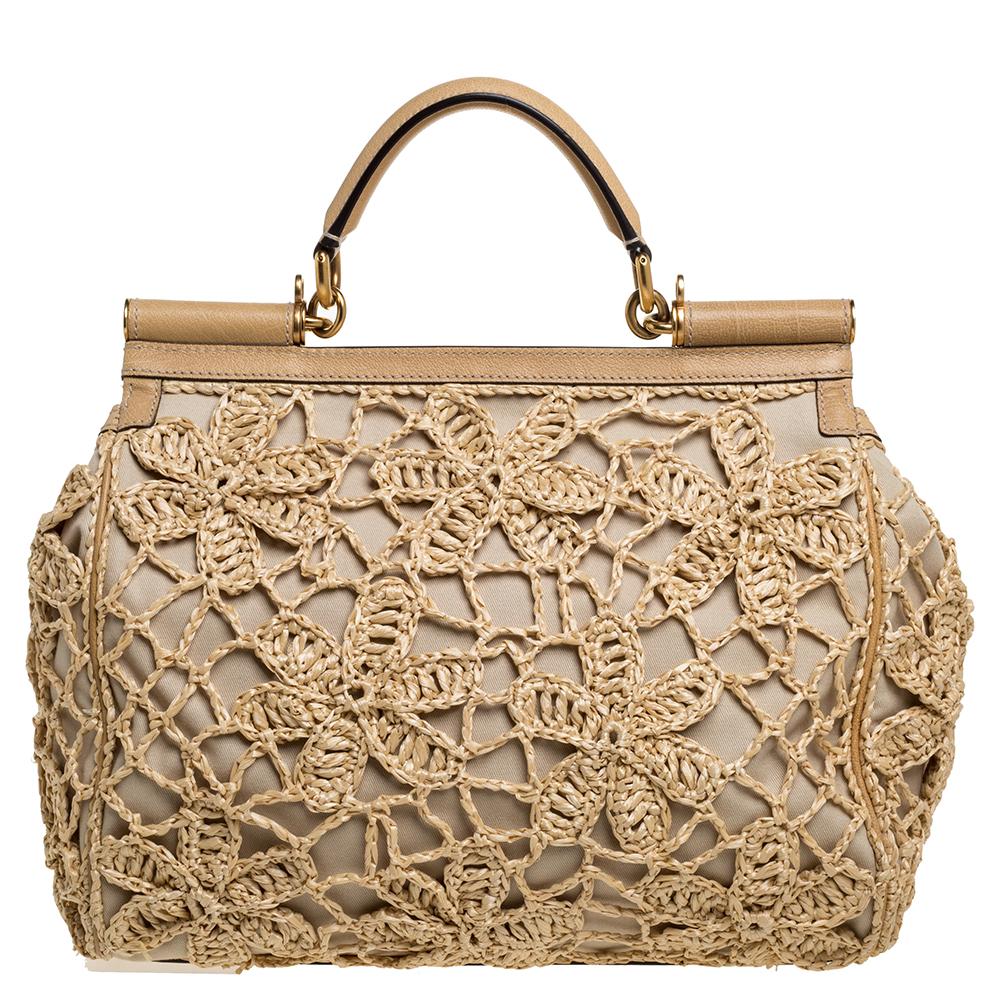 The Miss Sicily range of bags is one of the most celebrated creations from Dolce & Gabbana. This beige beauty beautifully embodies the spirit of extravagance and feminity that the Italian luxury brand carries. Crafted from crochet-knit raffia,