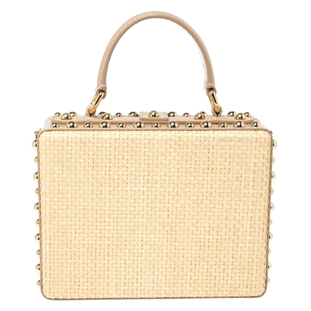 Statement bags from Dolce and Gabbana have always stood out and this beige creation validates that! It comes crafted from raffia and leather and flaunts a floral embroidered pattern on the front. It has been adorned with crystal embellishments and
