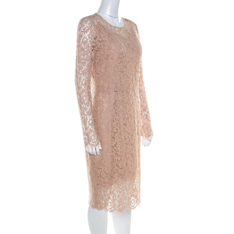Make room in your closet for this graceful creation from the house of Dolce&Gabbana. Designed for a subtle look, this beige sheath dress is fabulous for a formal event. This dress features lace overlay, full sleeves and a back zipper.

Includes: The