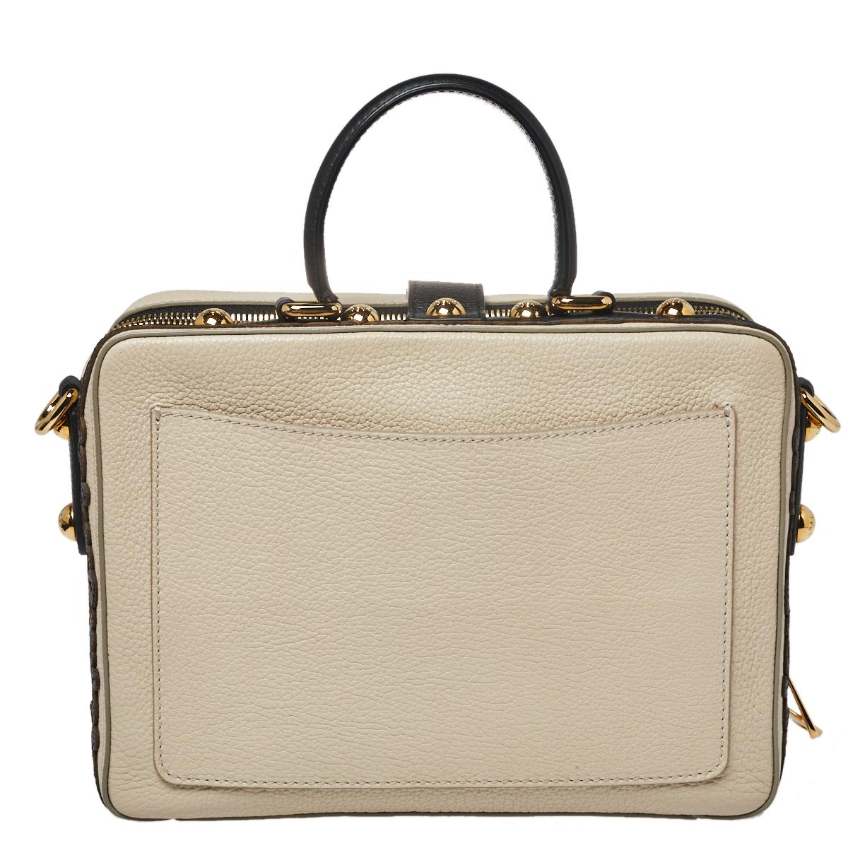 If you like to keep it ornate & luxe, go for this Dolce & Gabbana handbag. Crafted from beige-hued leather, it is enhanced with beautiful embellishments and gold-tone hardware. The bag features a top handle and a delicate floral embellishment on the