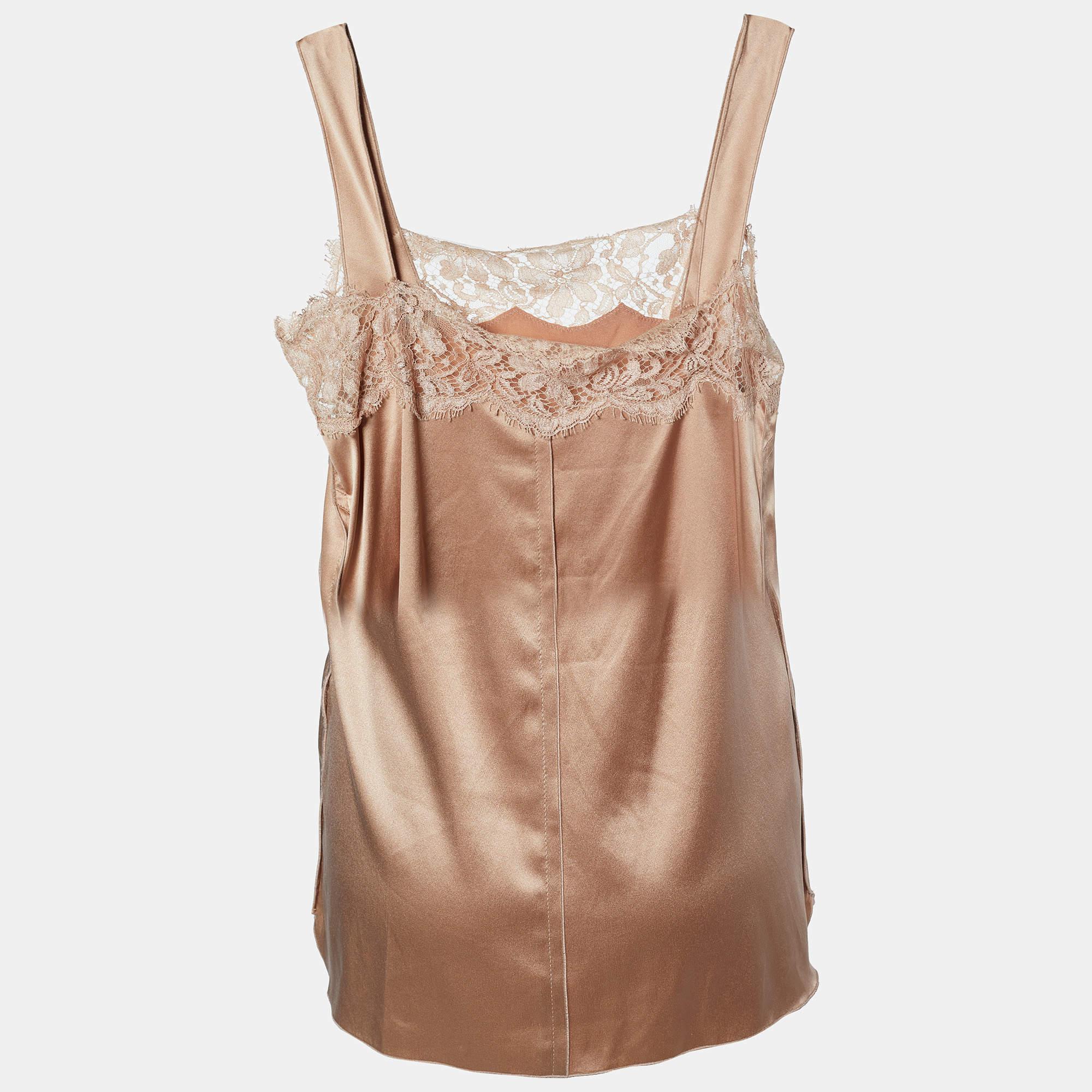 The Dolce & Gabbana top is a luxurious and elegant fashion piece. Made from high-quality satin, it features lace panels that exude sophistication. The cami style offers a relaxed fit.

