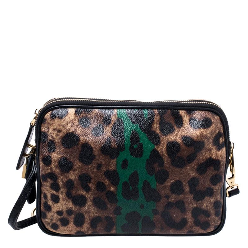 You know you're going to catch admiring glances when you swing this crossbody bag by Dolce & Gabbana. It has been crafted from leopard printed coated canvas and enhanced with gold-tone hardware. The bag has a top zipper that reveals a spacious