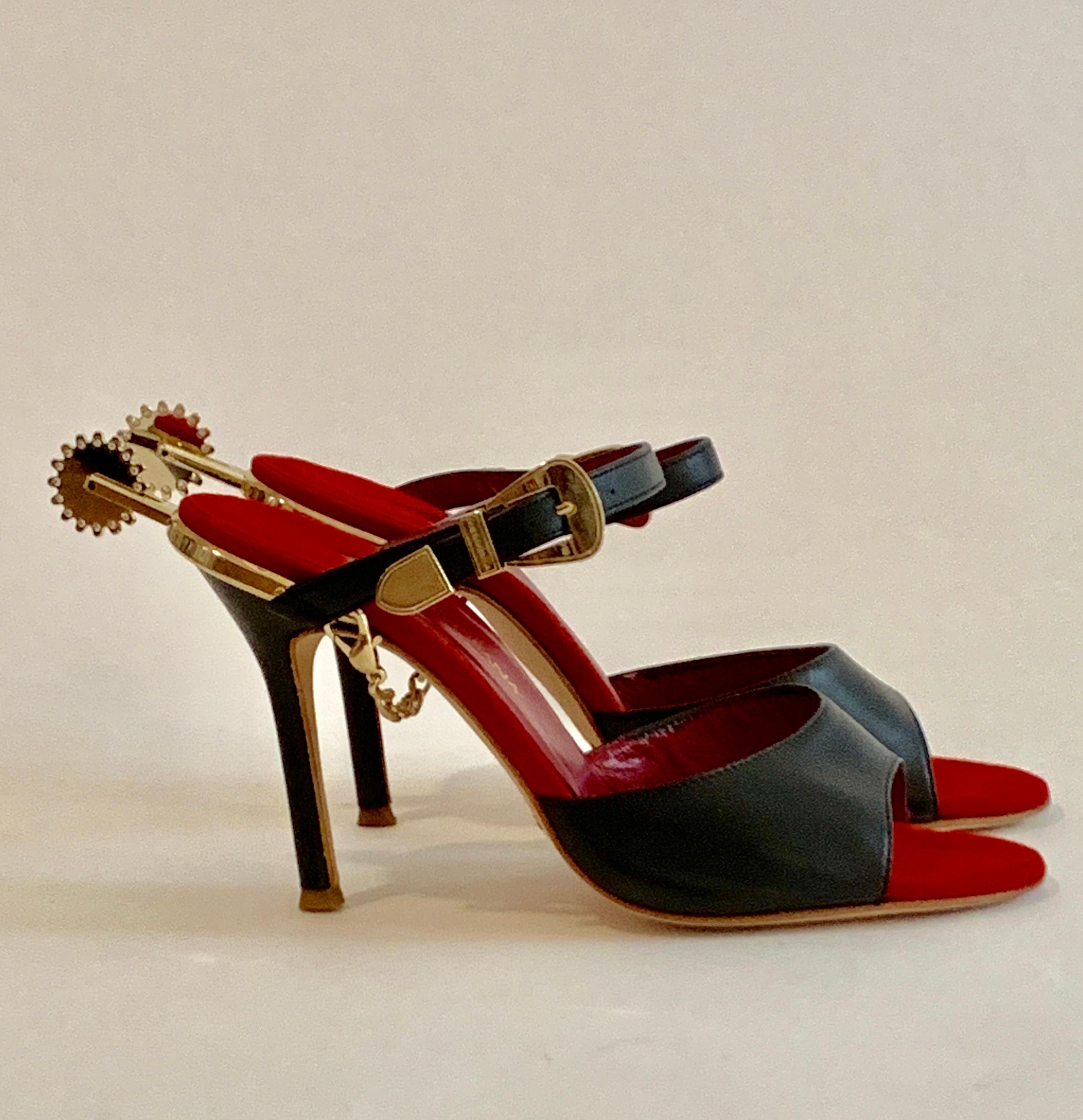 Amazing Western inspired Dolce & Gabbana black leather high heeled sandals with goldstone buckle, chain, and rhinestone accented spur detailing. Red suede insole. Slides on. Approximate 3.25