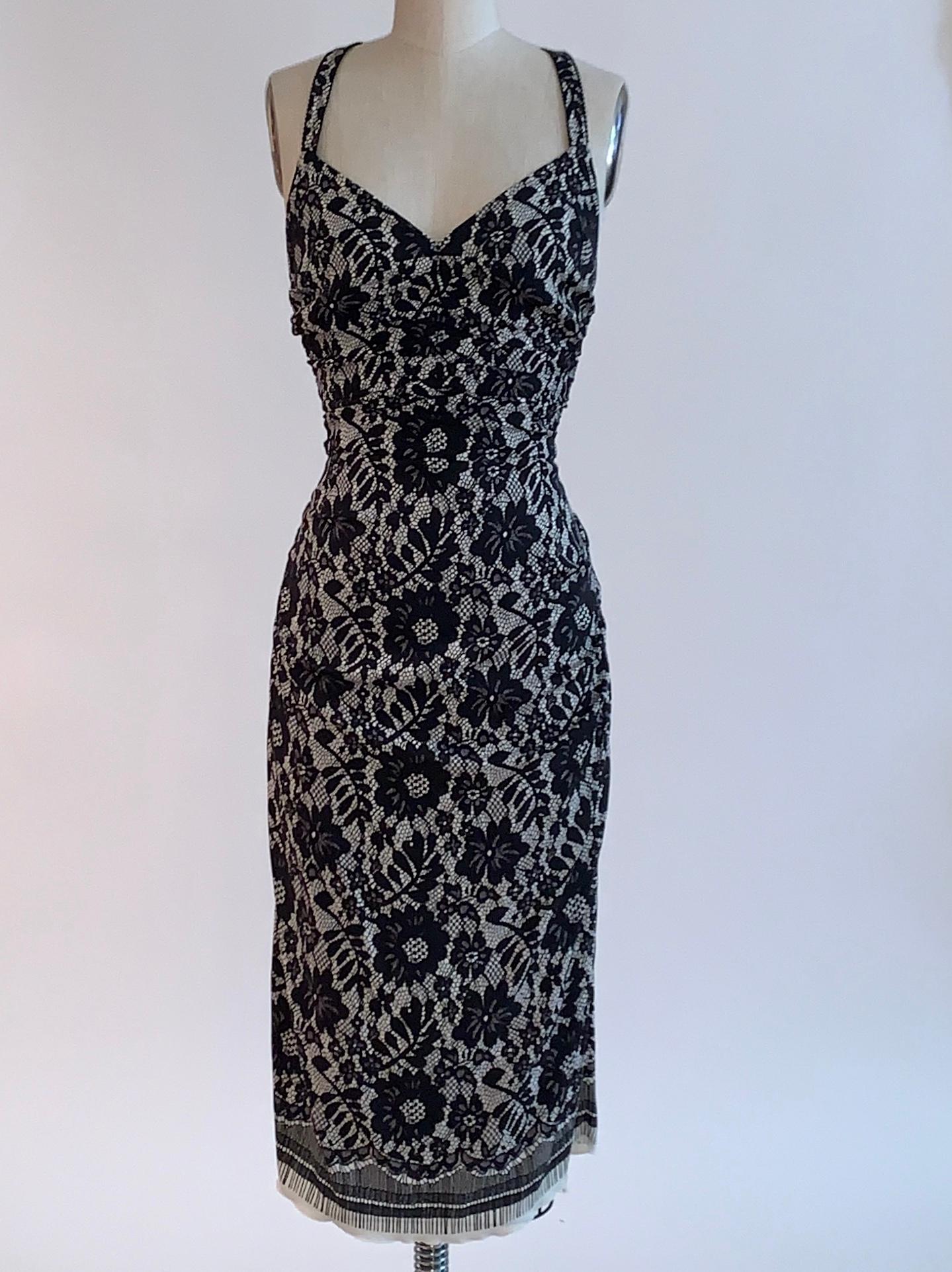 Dolce and Gabbana black and white lace print midi dress with ruching throughout. Lower back with crossed straps. Back zip and hook and loop closure. 

94% silk, 6% elastane.
Fully lined in 96% silk, 4% elastane.

Made in Italy.

Size IT 42,
