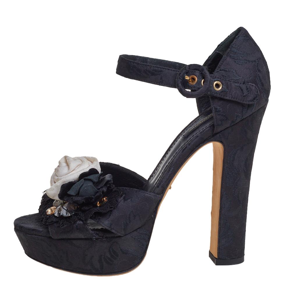 These beautiful Dolce & Gabbana sandals have been styled with perfection just so a diva like you can flaunt them. They've been crafted from black brocade fabric and designed with eye-catching floral embellishments on the vamps. ankle straps with
