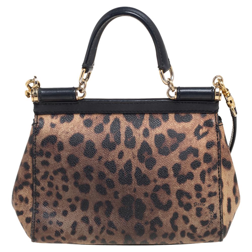 Meticulously crafted into an eye-catchy shape, this Miss Sicily bag from Dolce & Gabbana exudes just the right amount of charm and elegance! It is made from black-brown leopard printed coated canvas and leather, with a gold-toned logo plaque