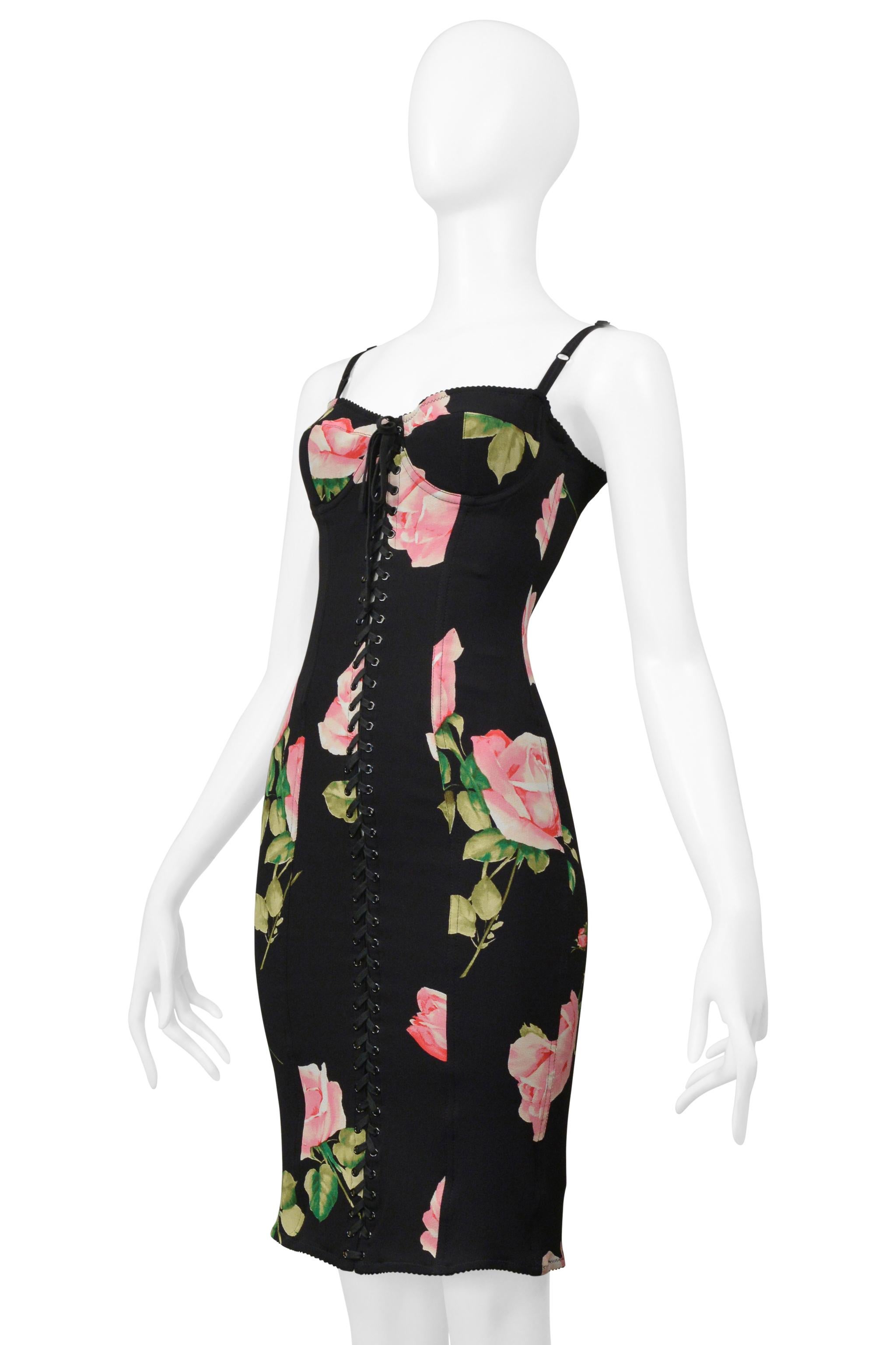 Resurrection Vintage is excited to offer a vintage Dolce & Gabbana black corset dress with stretch featuring a black bra top with adjustable straps, corset laces down the center front, exposed back, center back slit with hook and eye closure, center