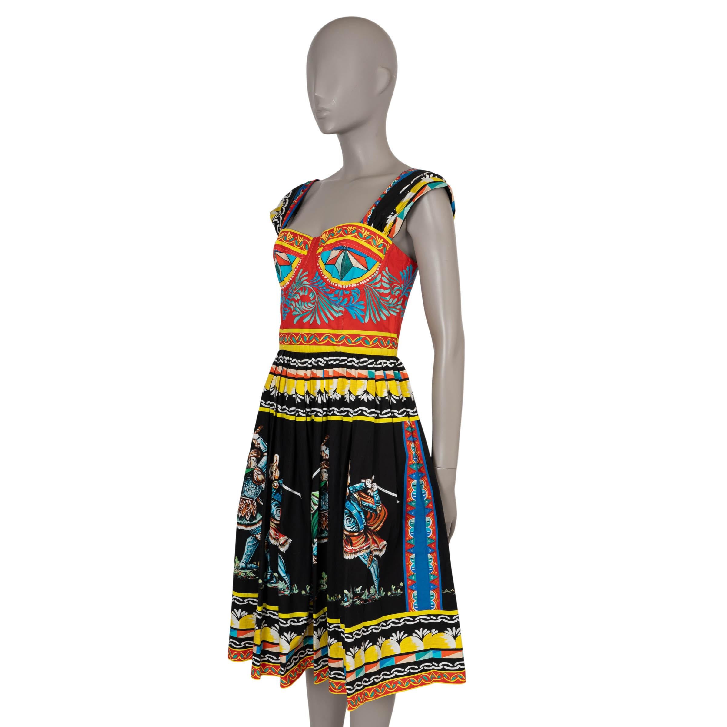 This 100% authentic Dolce & Gabbana dress in black, red, yellow, and blue Carretto-printed poplin cotton (100%) captures the essence of Sicilian heritage with its vibrant and artistic design. Featuring a fit-and-flare silhouette, it is designed with