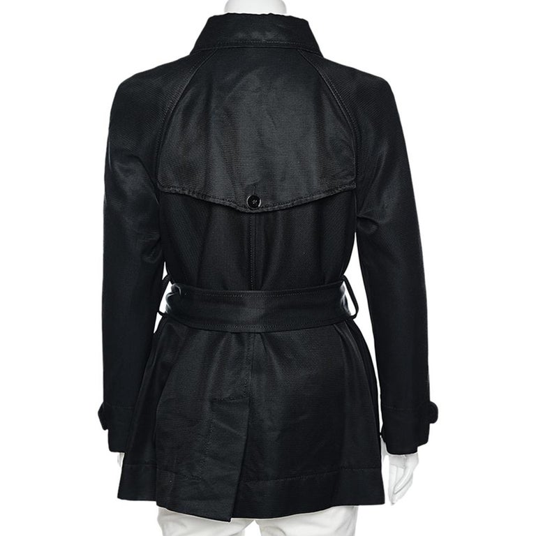 Look stunning and classy as you step out wearing this jacket from the House of Dolce & Gabbana. It has been stitched using black cotton fabric and features a belted detail, a button-front feature, and two external pockets. It has long sleeves.